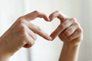 A heart symbol is made by putting fingers together.